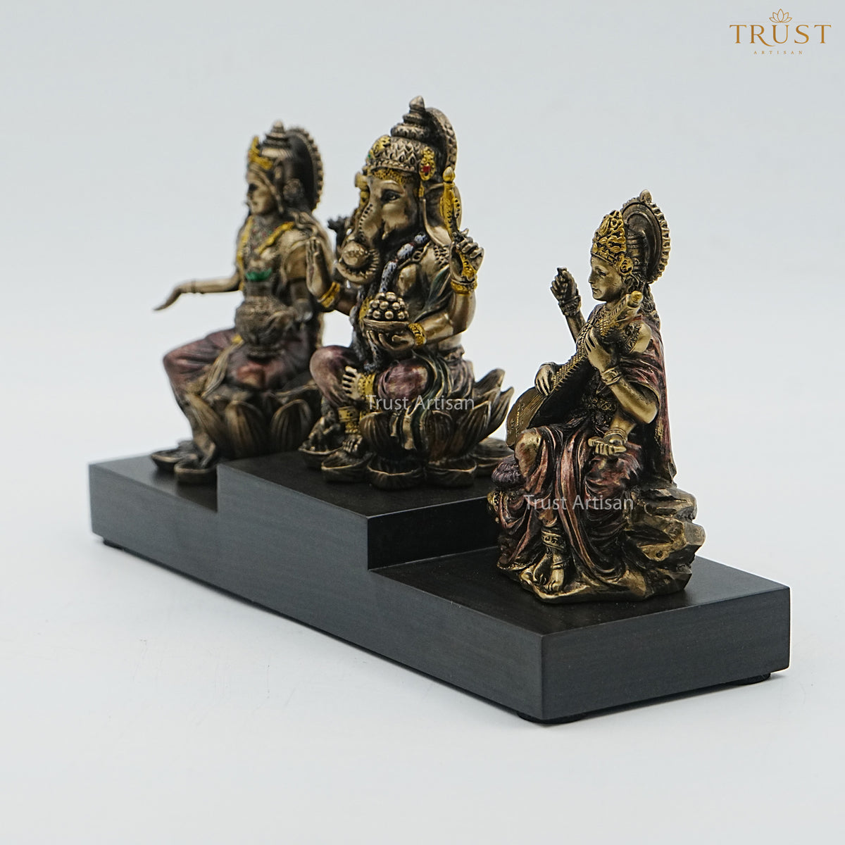Handcrafted Resin Laxmi Ganesh Saraswati Idol Set – Seated Trio on Tiered Wooden Base, Antique Bronze Finish for Home Temple & Diwali Pooja